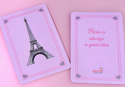 a pink playing cards with a picture of a tower