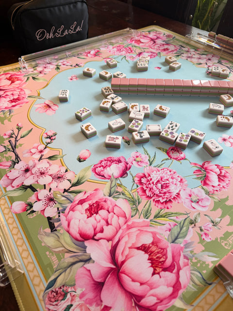 Floral-patterned table with a decorative guitar and dice