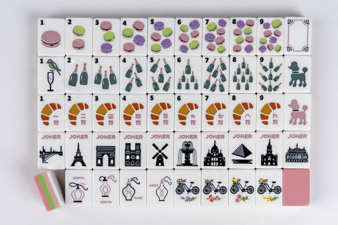 Colorful Mahjong tiles featuring macarons, champagne, croissants, and iconic landmarks, made of durable ceramic.