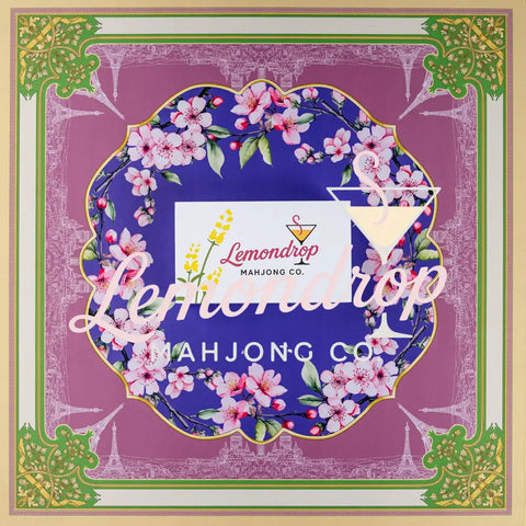 Lemondrop Mahjong Co. floral-themed game mat with vibrant purple and green design featuring cherry blossoms.
