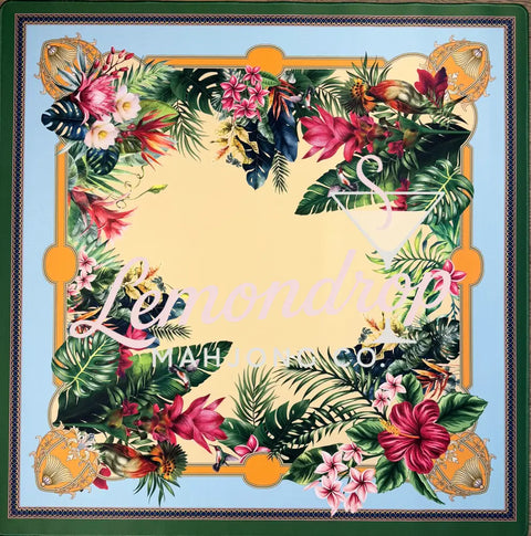 Decorative square with tropical floral and leaf design on a light gold background