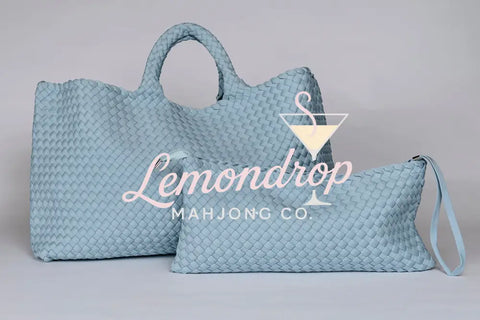 Light blue woven leather tote and pouch set, stylish and versatile for daily use.