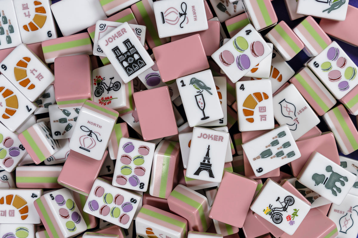 Collection of colorful game tiles with various designs on a surface