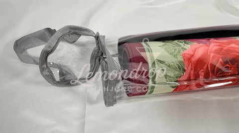 a wine bottle with a rolled up mat