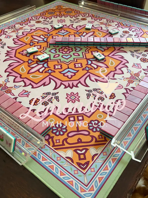 a table with a colorful rug and dominoes