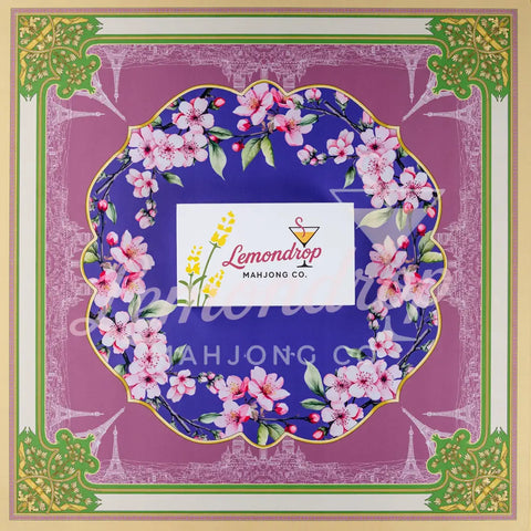 Lemondrop Mahjong Co. floral-themed game mat with vibrant purple and green design featuring cherry blossoms.