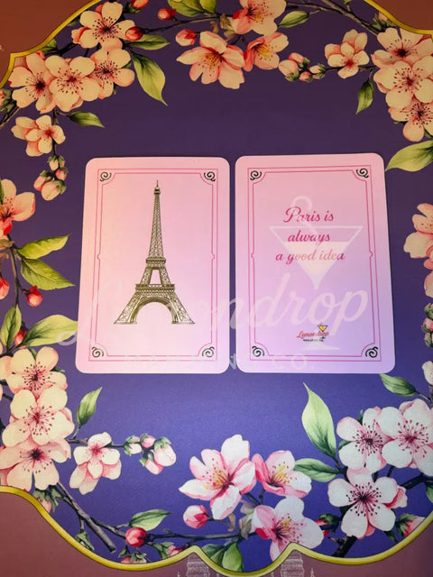 two plastic shufflers, one featuring an image of the Eiffel Tower while the other side says Paris is always a good idea 