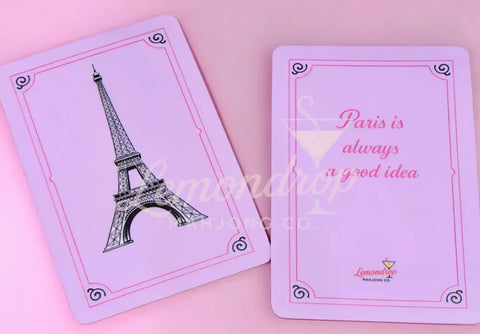 a pink playing cards with a picture of a tower