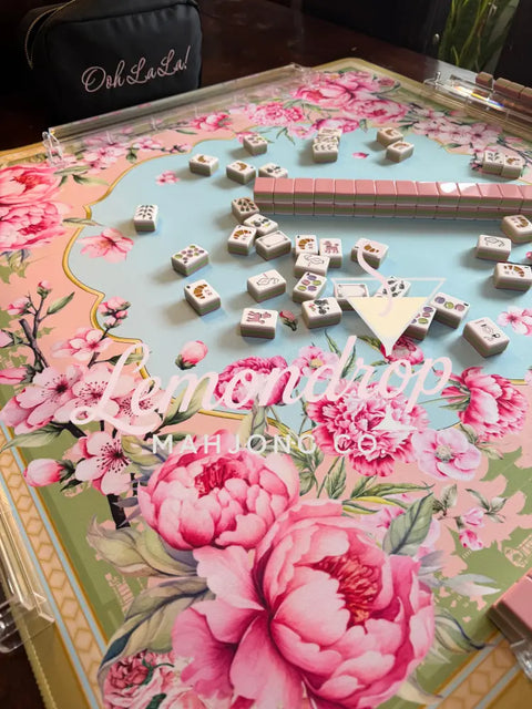Floral-patterned table with a decorative guitar and dice
