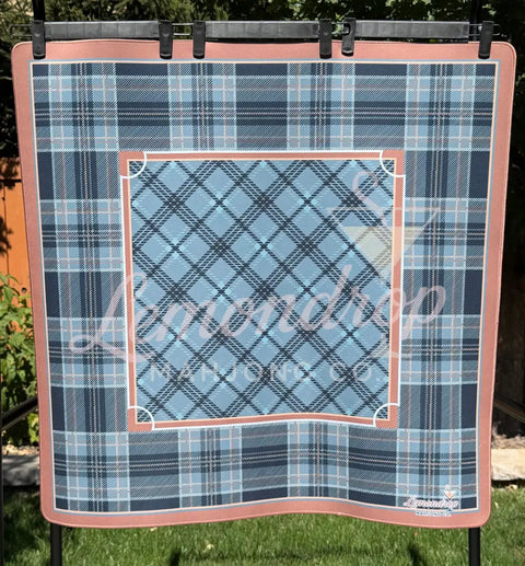 a plaid blanket on a metal rack